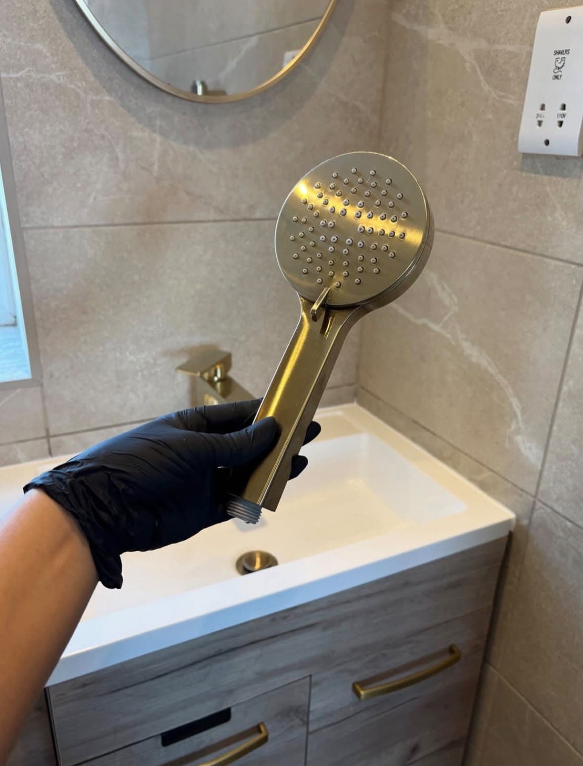 A gold-finish showerhead cleaned and polished